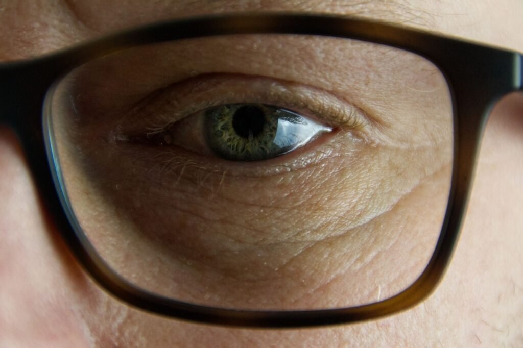 close de um olho com oculos preto retangular